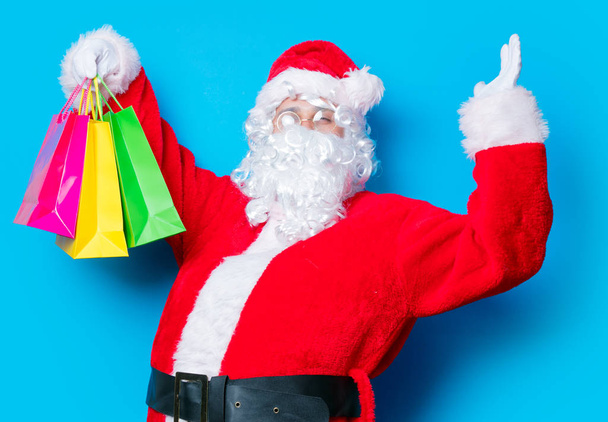 Santa Claus have a fun with shopping bags - Photo, Image