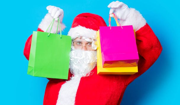 Santa Claus have a fun with shopping bags - 写真・画像