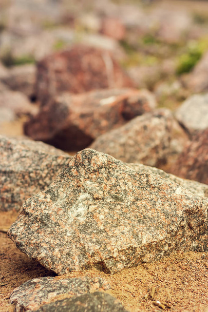 A large pile of limestone debris on the seashore.Stone of granite rock with sharp edges. - Foto, imagen