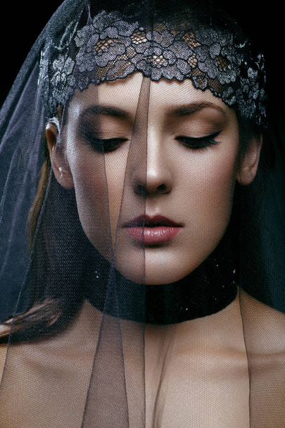 Beautiful girl with black lace veil - Fotó, kép