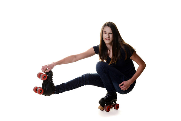 teen girl doing shoot the duck roller skate move - Fotó, kép