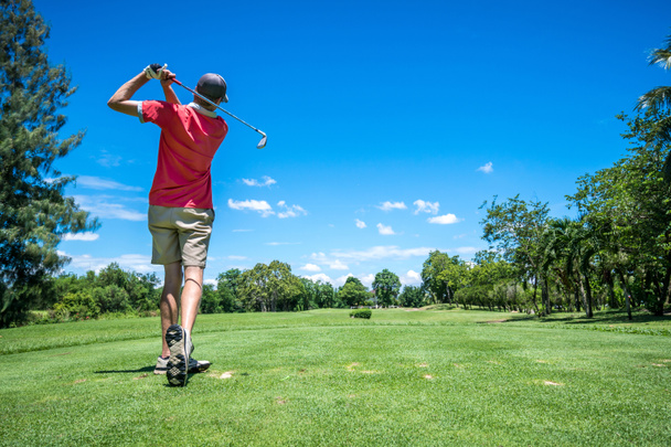 Golfer tee off with golf club
 - Фото, изображение