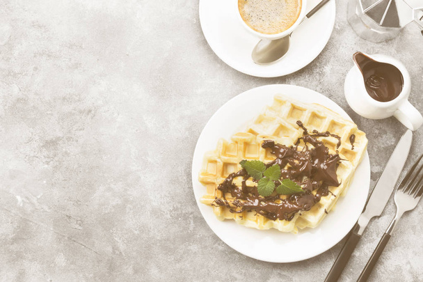 Waffles on white plate with chocolate and mint, coffee, sauce-bo - 写真・画像