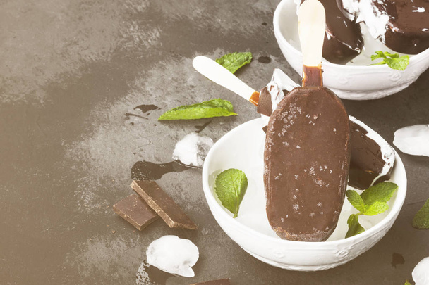 Vanilla ice cream on stick covered with chocolate glaze on a dar - Fotoğraf, Görsel