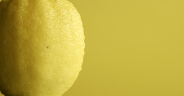 composition of lemons, leaves and ice cubes. Covered by water drops. Fresh summer fruit composition - Πλάνα, βίντεο
