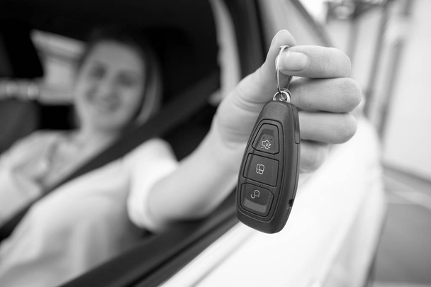 Black and white closeup photo of happy woman showing car keys th - Photo, Image