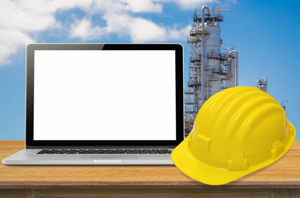 Yellow safety helmet and laptop  - Photo, Image