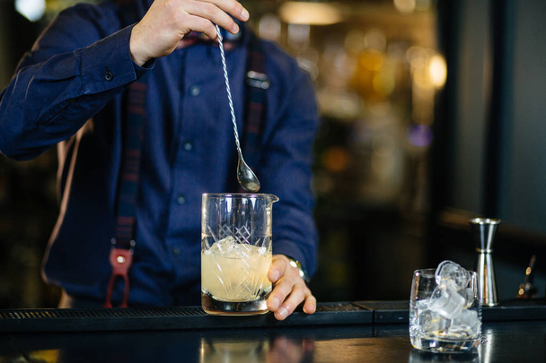 Bartender is making cocktail at bar. - Фото, изображение