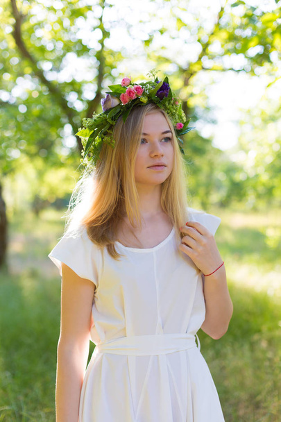 Beautiful young woman in flower wreath  - Fotoğraf, Görsel