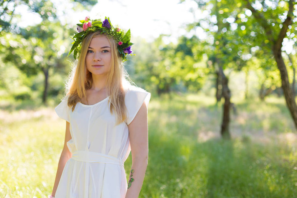 Beautiful young woman in flower wreath  - Photo, Image