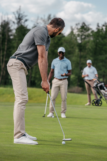 Golfer zielt mit Schläger auf Ball - Foto, Bild