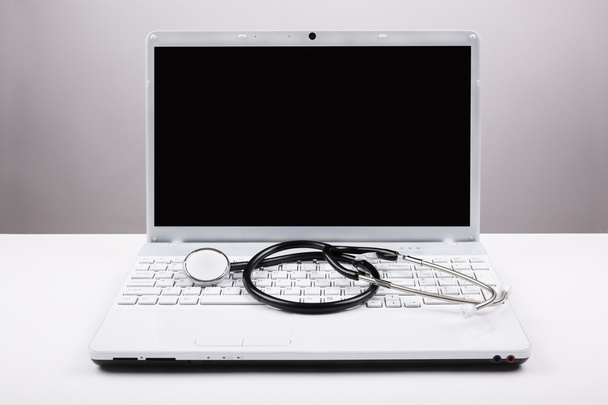 stethoscoop en white laptop - Foto, afbeelding