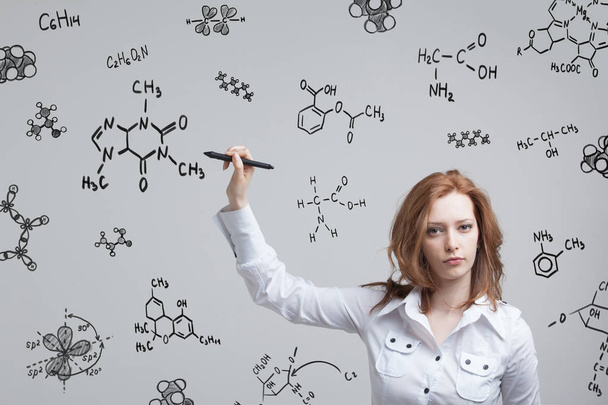 Woman chemist working with chemical formulas on grey background. - Valokuva, kuva