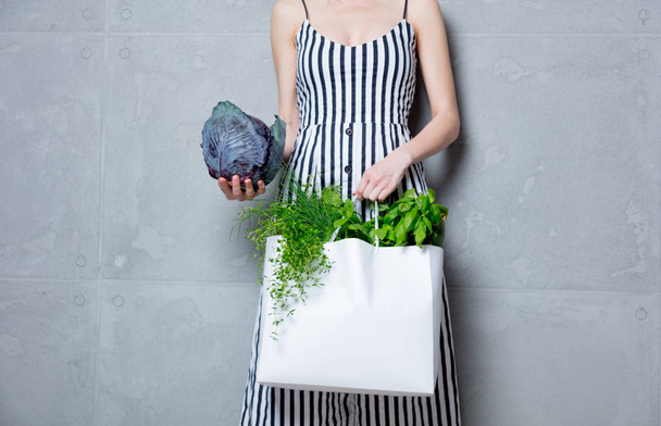 woman holding bag with vegetables - 写真・画像