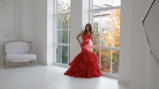 Gergeous woman in red dress posing in studio. - Footage, Video