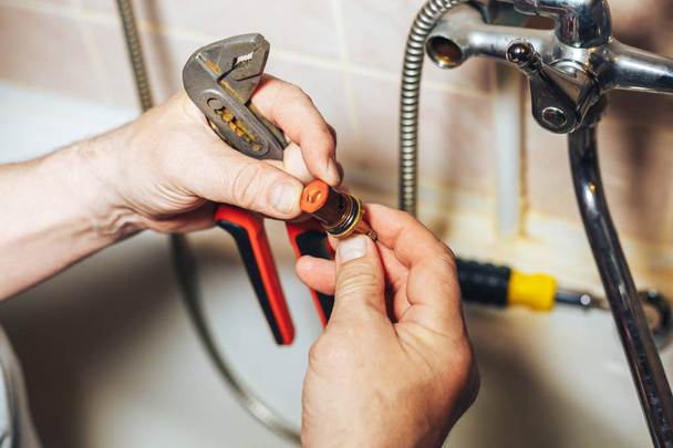 Man repair and fixing leaky old faucet in bathroom - Φωτογραφία, εικόνα