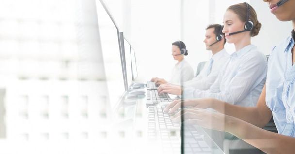 Customer service assistants  with headsets with bright office background - Photo, image