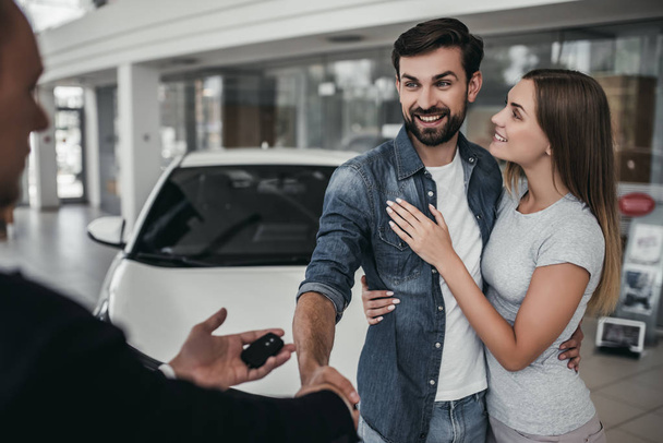 Couple at car dealership - Фото, зображення
