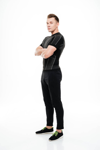 Sportsman standing with arms folded and looking at camera - Foto, imagen