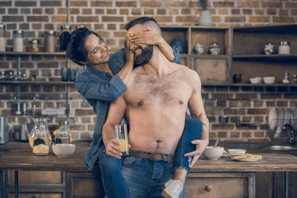 Couple hugging in kitchen - Photo, Image