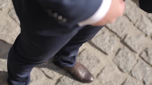 Mens legs in shoes and suits on the stone floor - Video