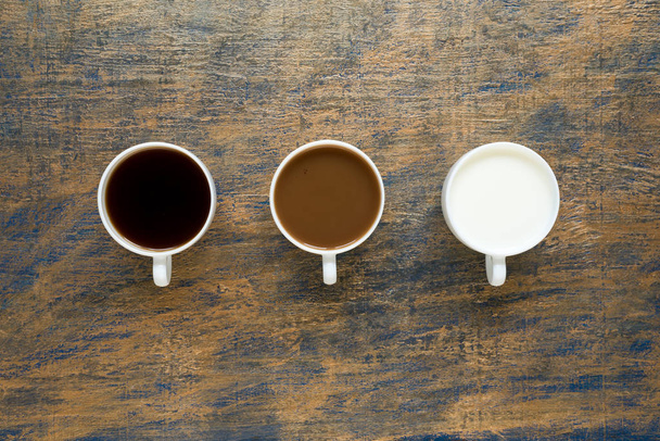 Three cups with coffee and milk on grunge background - Photo, image