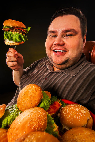Kövér ember evés gyorsétterem hamberger. Túlsúlyos fő részére reggelivel. - Fotó, kép