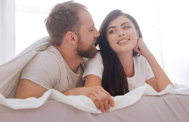 Millennial couple flirting in bed - Фото, изображение