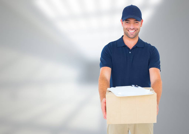 Delivery Courier with box in front of blurred background and copy space  - Фото, зображення