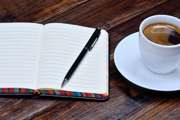 Notepad with pen and coffee cup on table - Photo, Image