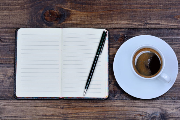 Notebook with pen and coffee on table - Photo, Image