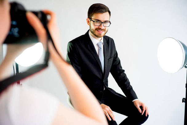 Photographer taking picture of a model in studio - Zdjęcie, obraz