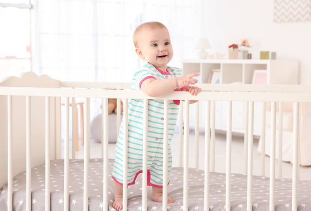 little baby standing in crib  - Photo, image