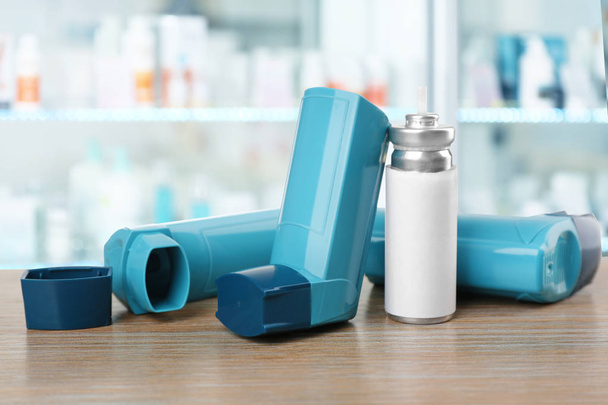 Concept of health care and asthma. Inhalers on counter at pharmacy - Foto, Bild