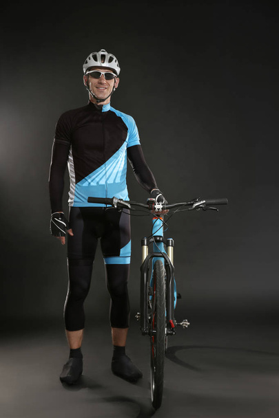 Young sporty cyclist with bicycle - Foto, Imagen