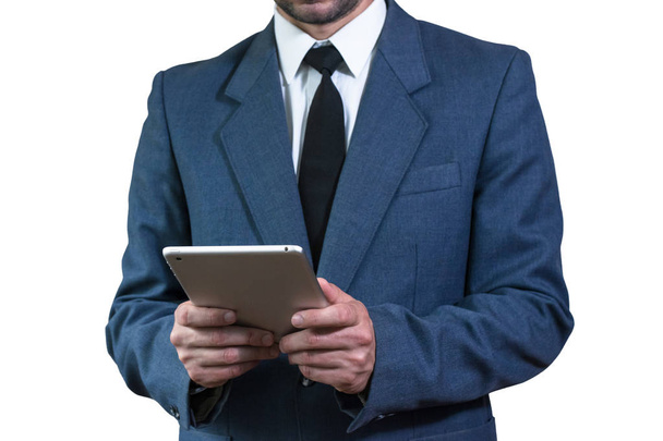 Businessman in a jacket holding a tablet - Фото, зображення
