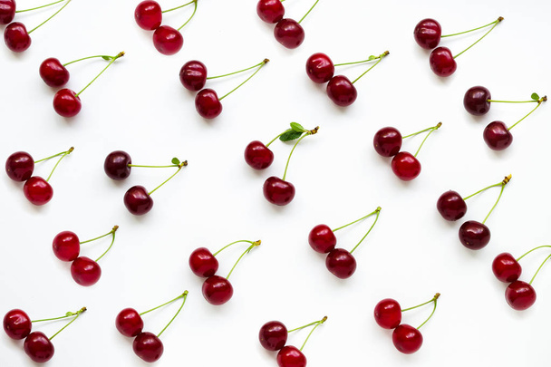 Cherries with petioles lined in rows on a white background. Pattern of cherries. Fruit Pattern - Foto, Imagem