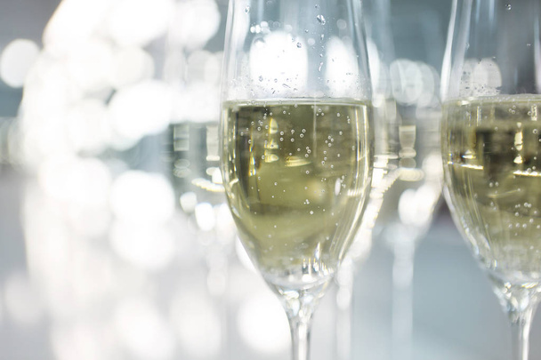 Champagne glasses on white background in bright lights - Photo, Image