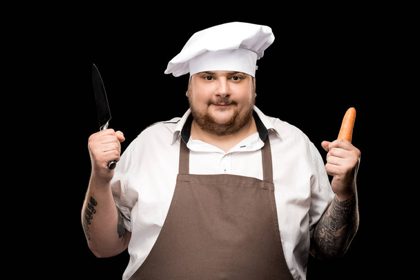 Chef holding carrot  - Photo, Image