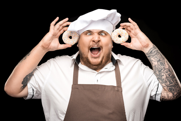 Chef holding doughnuts  - Foto, afbeelding