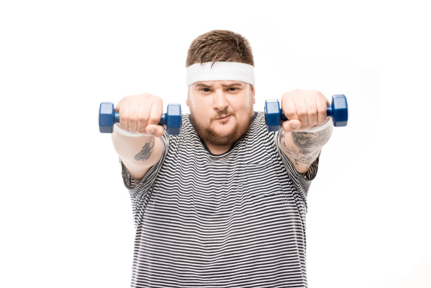 chubby man exercising with dumbbells - Photo, Image