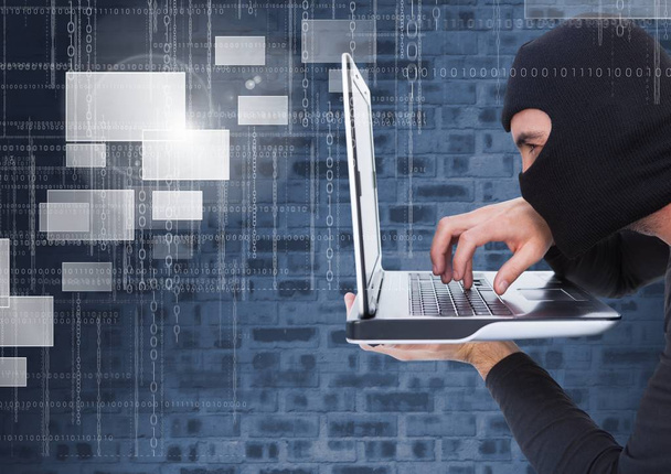 Hacker using a laptop - Фото, изображение