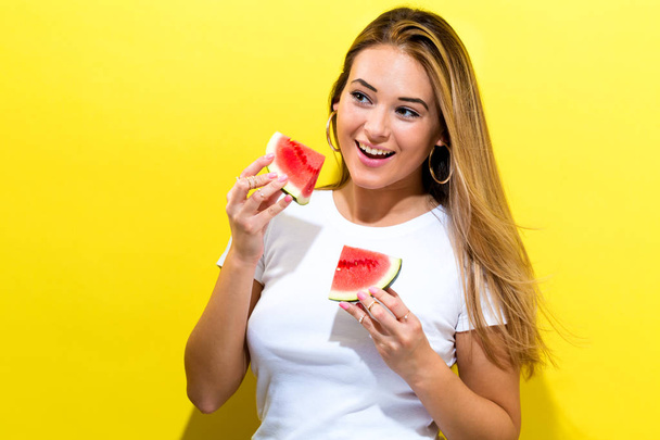 Happy young woman holding watermelons - Zdjęcie, obraz