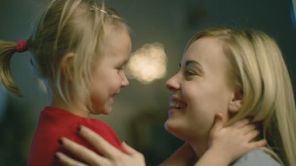 Close-up Shot of a Beautiful Mother Holding Her Cute Blonde Daughter and Smiling. - Filmmaterial, Video