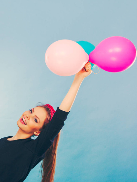 Lovely smiling girl holds colorful balloons. - Fotó, kép