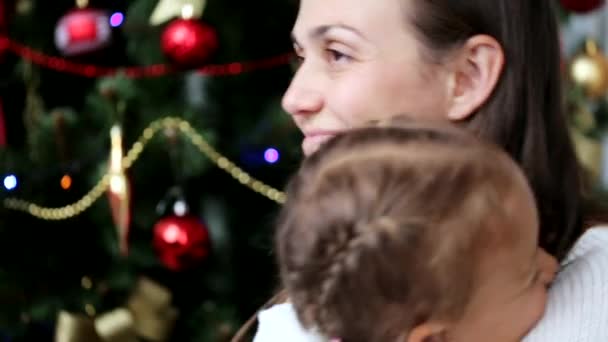 Happy mother having fun with her kids in christmas time next to christmas tree - Materiaali, video
