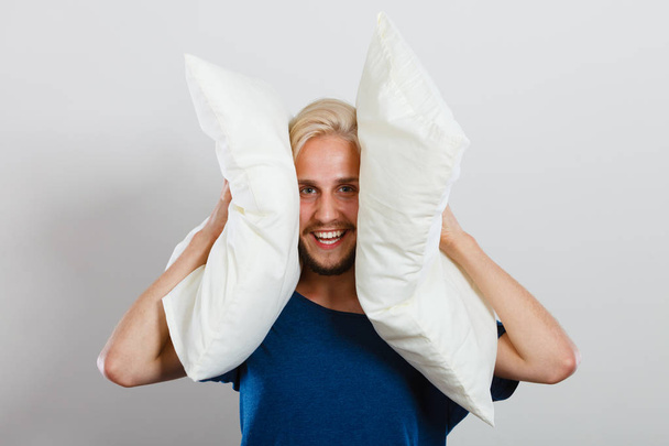 Man playing with pillows, good sleep concept - Fotó, kép
