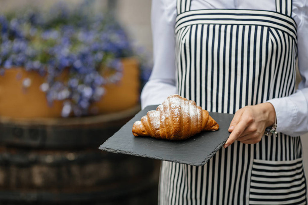 woman serving  fresh croissant - Photo, image