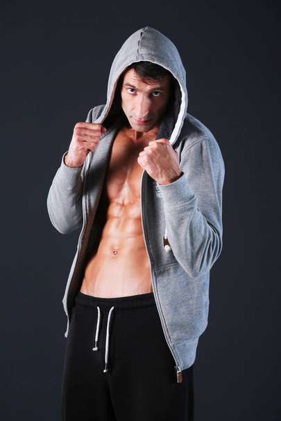 Profile view of young man practicing boxing .Personal instructor. Personal training. - Foto, Imagen