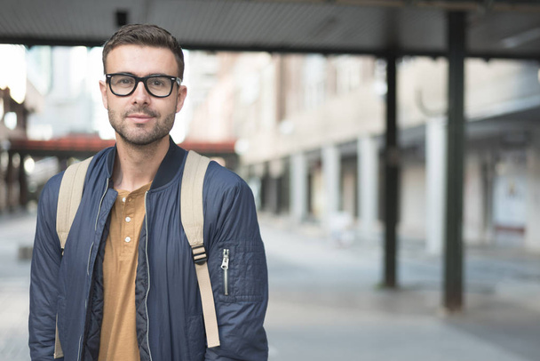 student man with backpack smiling  - Valokuva, kuva